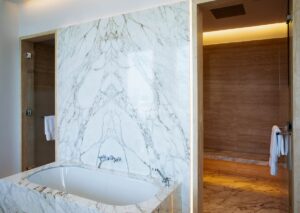 marble backed bath shower combination in The Lana Dubai