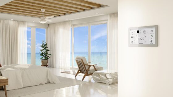 white on white hotel guestroom with wooden ceiling and floor to ceiling windows with ocean view