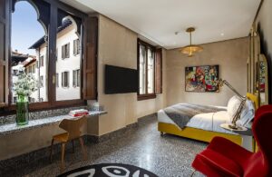 hotel guestroom with terrazzo floors and gothic windows with view over Florence