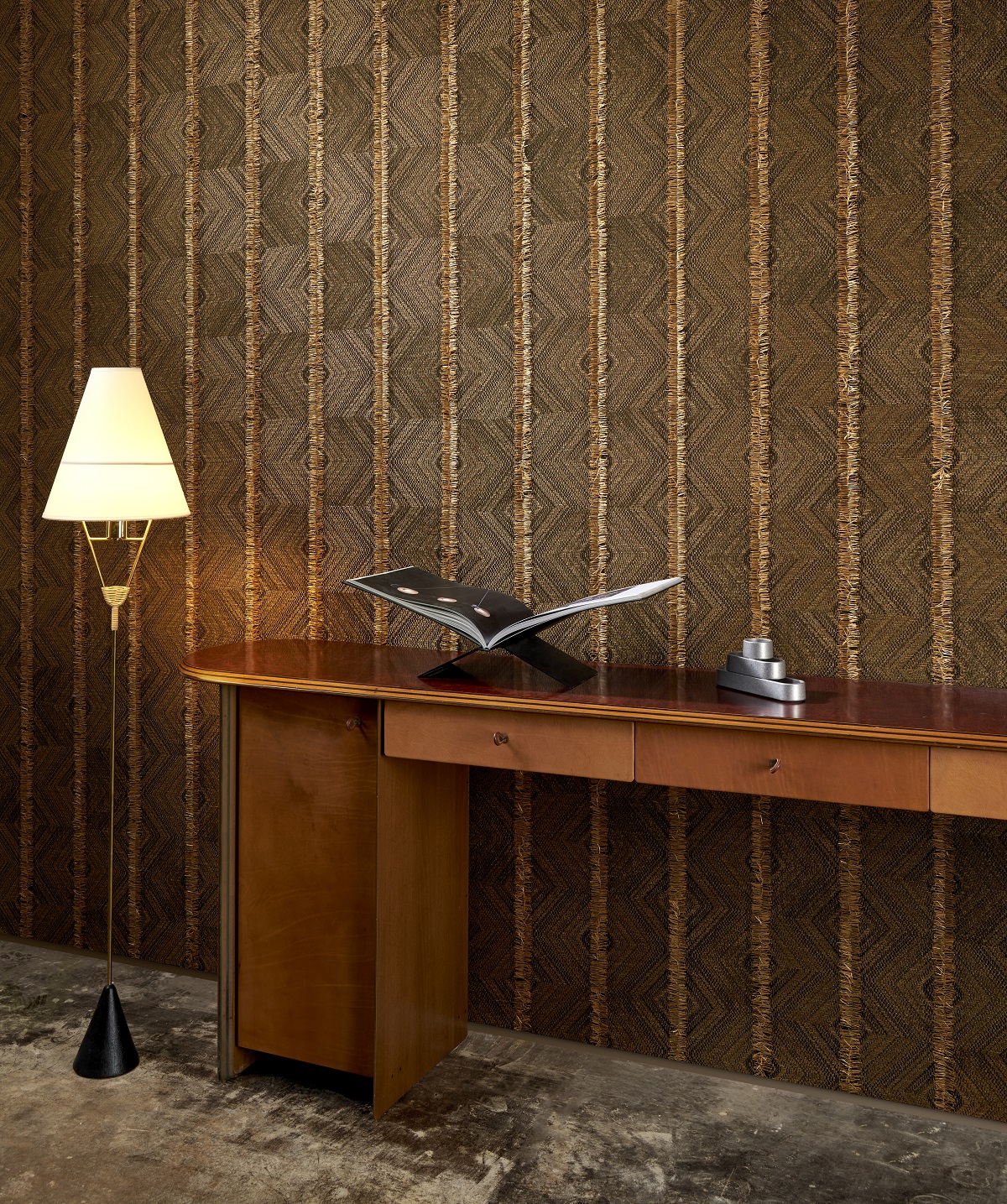 wooden table and standing lamp in front of textured fabric wallcovering from Arte