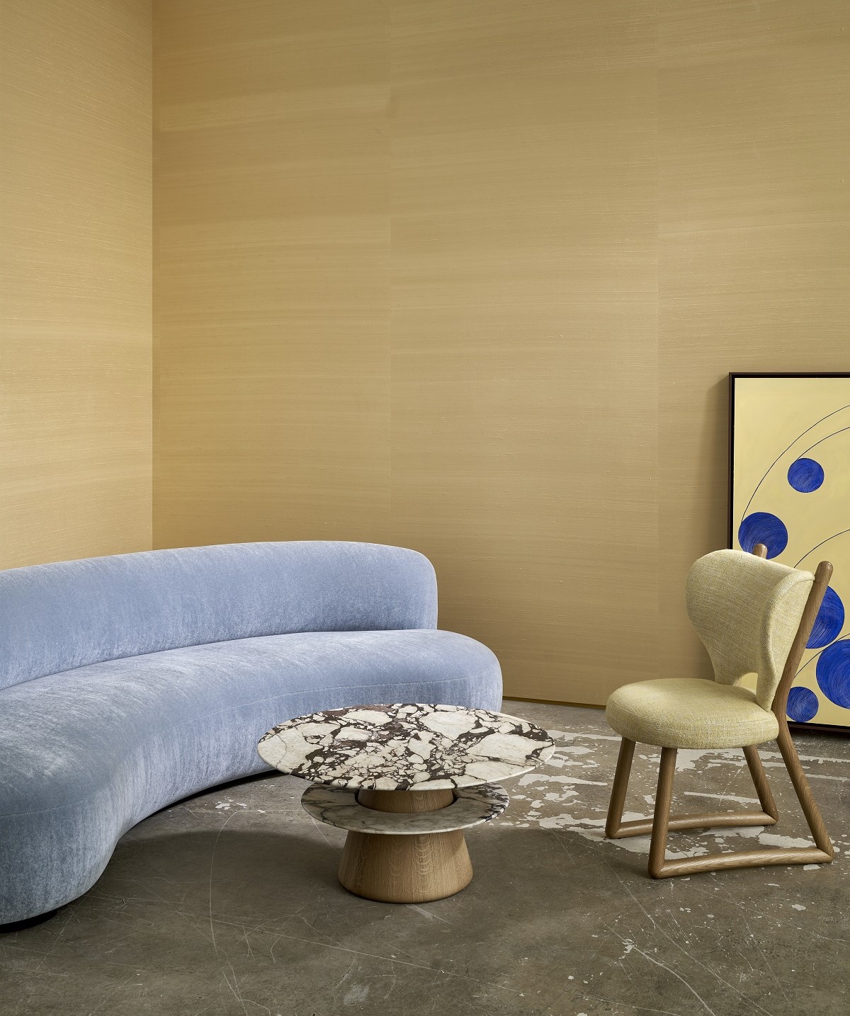 light blue curved couch in front of gold dupion silk wallcovering