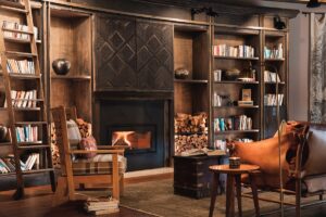 library shelves with leather seating and carved wooden details at safari lodge
