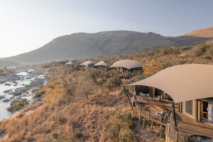 view across the tented camp of Madwaleni river Lodge with river below the tented suites