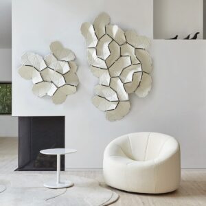 white pumpkin chair from Ligne Roset on white carpet in front of white sculptural wall decoration