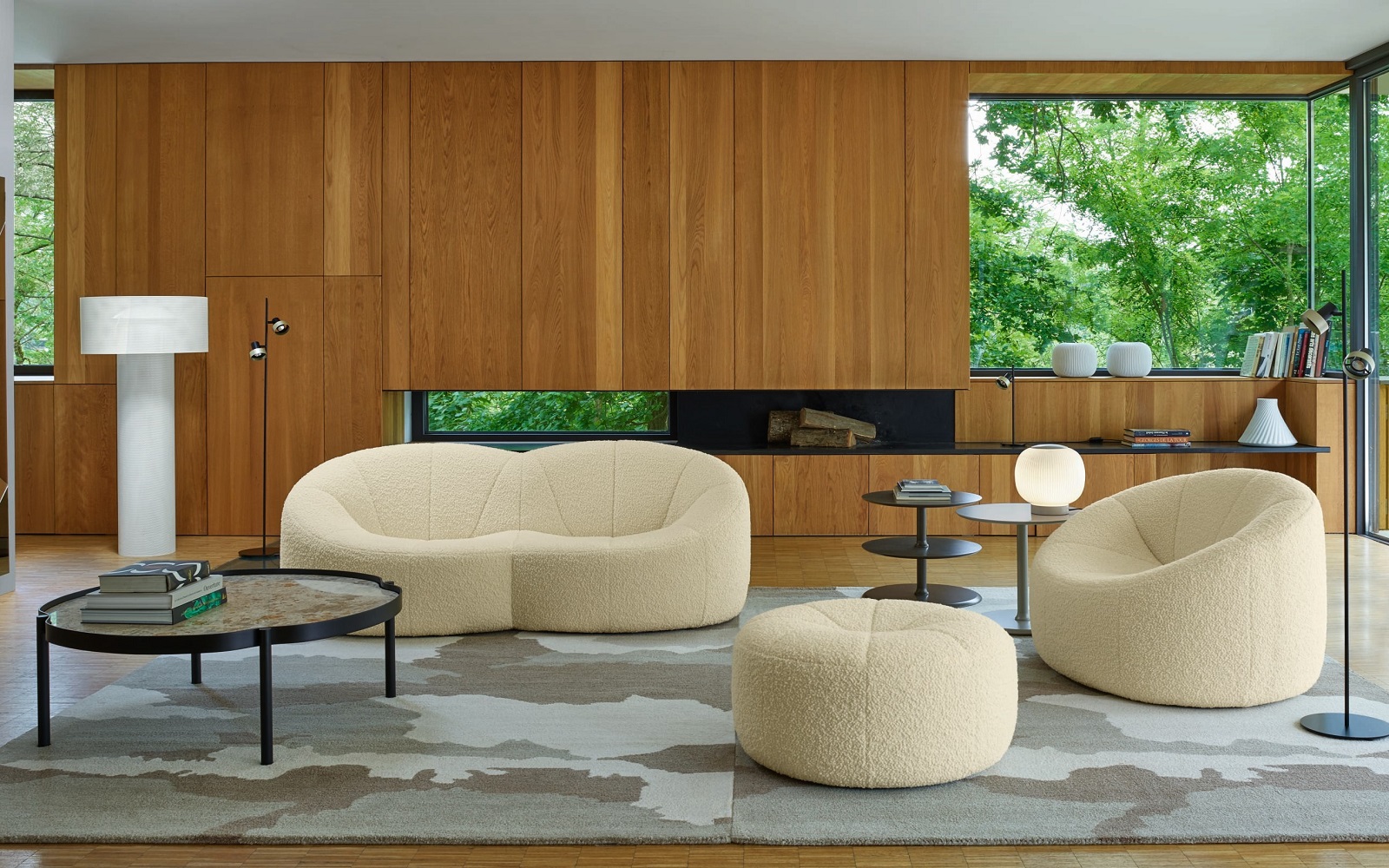 lounge with wooden panelled walls and mid century design furniture in cream from Ligne Roset