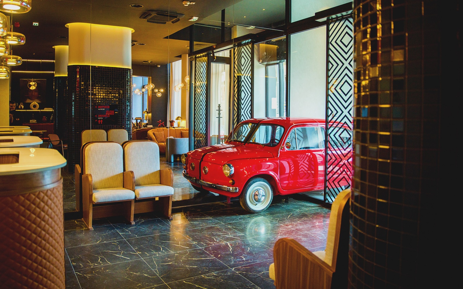 Lobby in Radisson Red Belgrade with red car in entrance