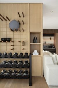 a corner of a SIRO guestroom with gym equipment and weights