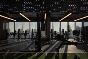 view of lighting and gym equipment in front of floor to ceiling windows over Dubai