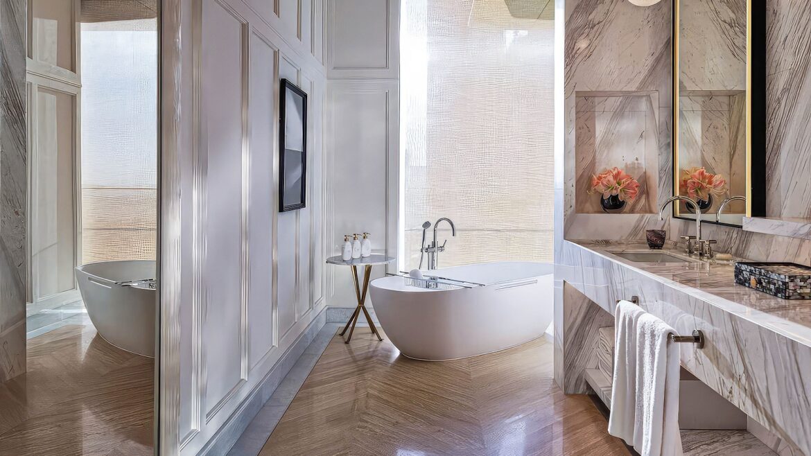 bathroom with marble surfaces, wooden floors and freestanding bath from Sanipex in The Lana Dubai