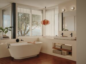 view of bathroom with corner window behind freestanding bath and double vanity