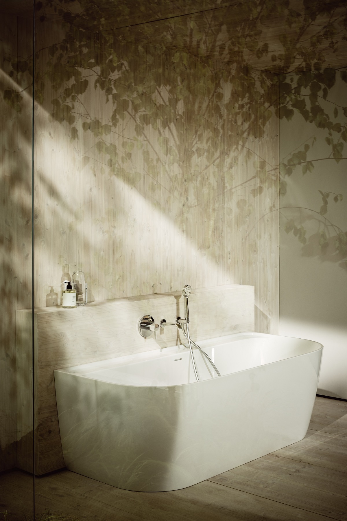 curved freestanding bath set against the wall