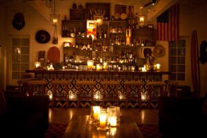 tiled bar with gallery wall behind and candle light