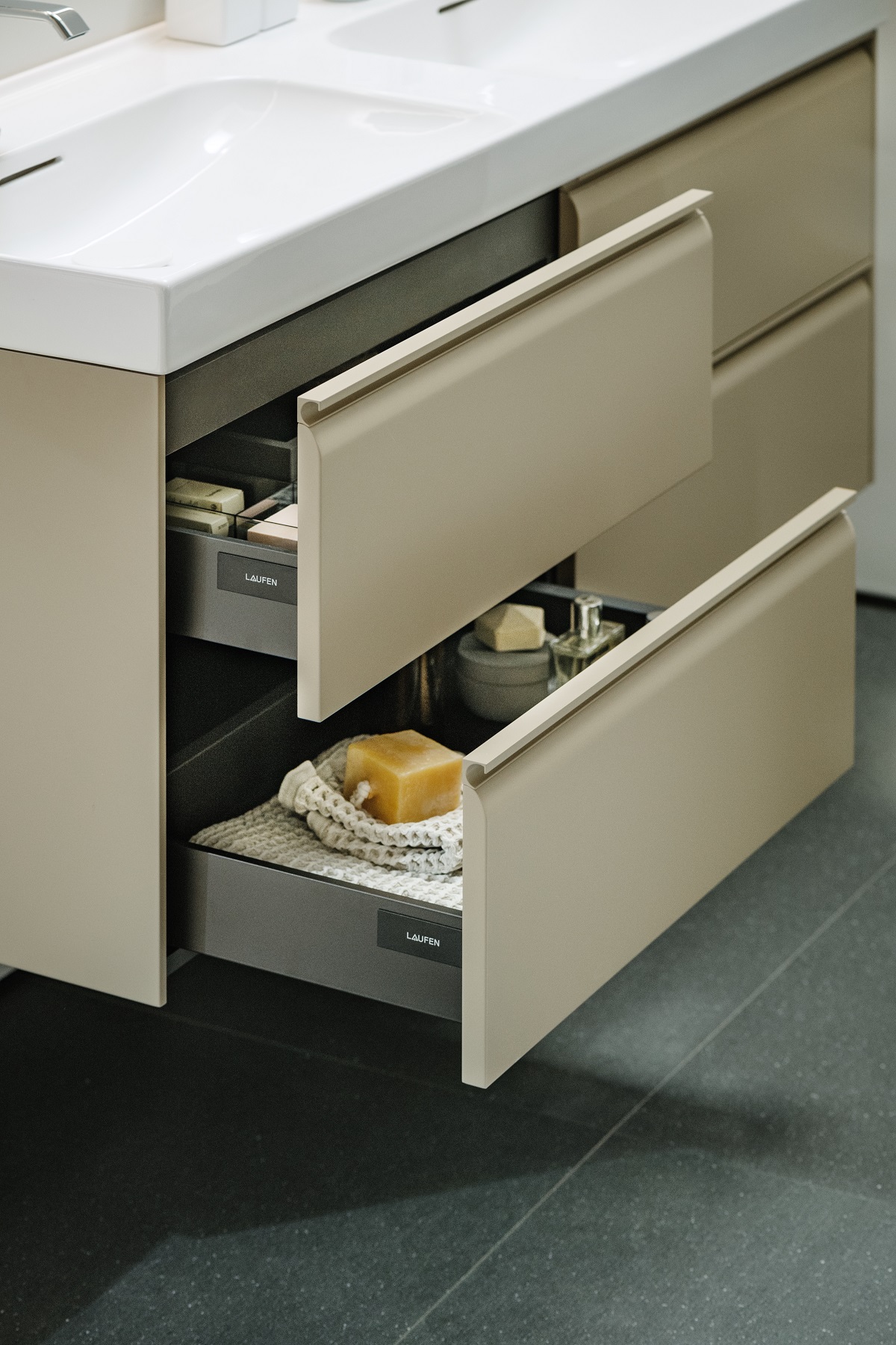 soft open bathroom drawers in cream with white basin