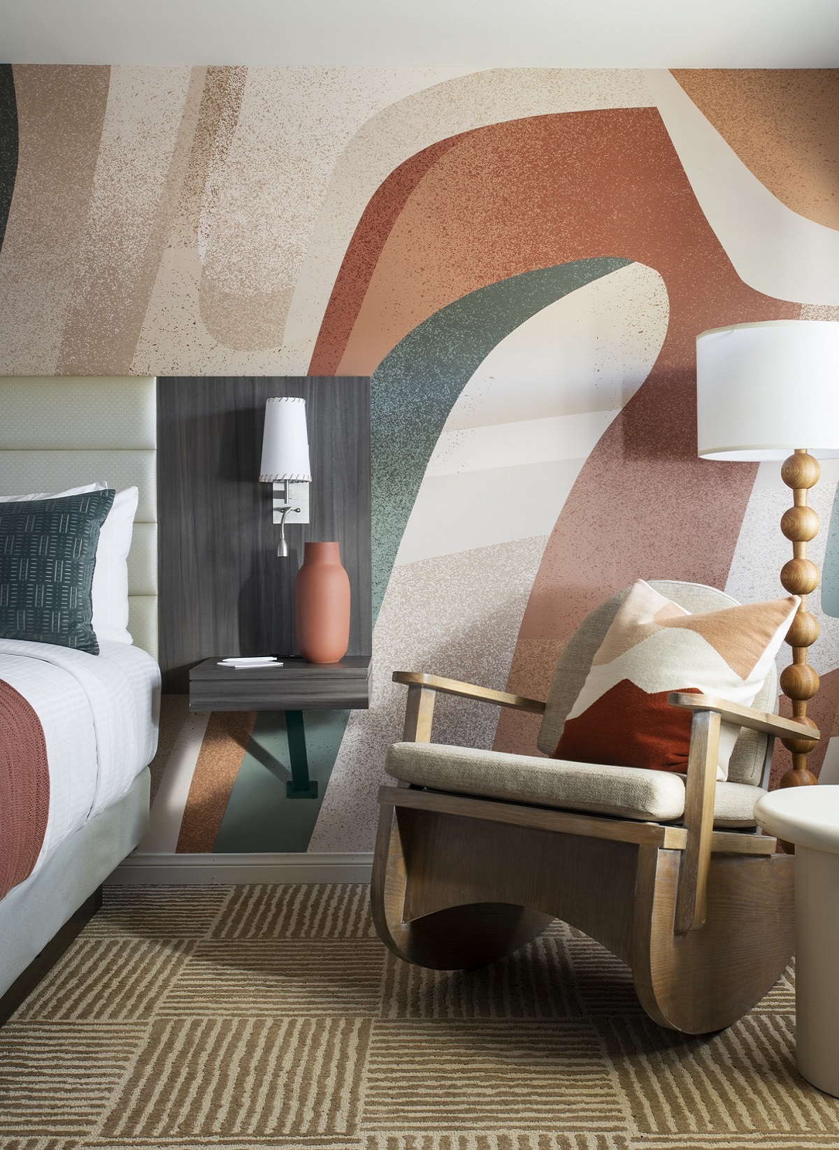wooden rocking chair and lamp detail with painted wall mural behind