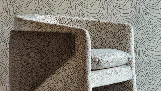 black and stone patterned wallpaper with patterend chair in same colourway from Harlequin Reflect
