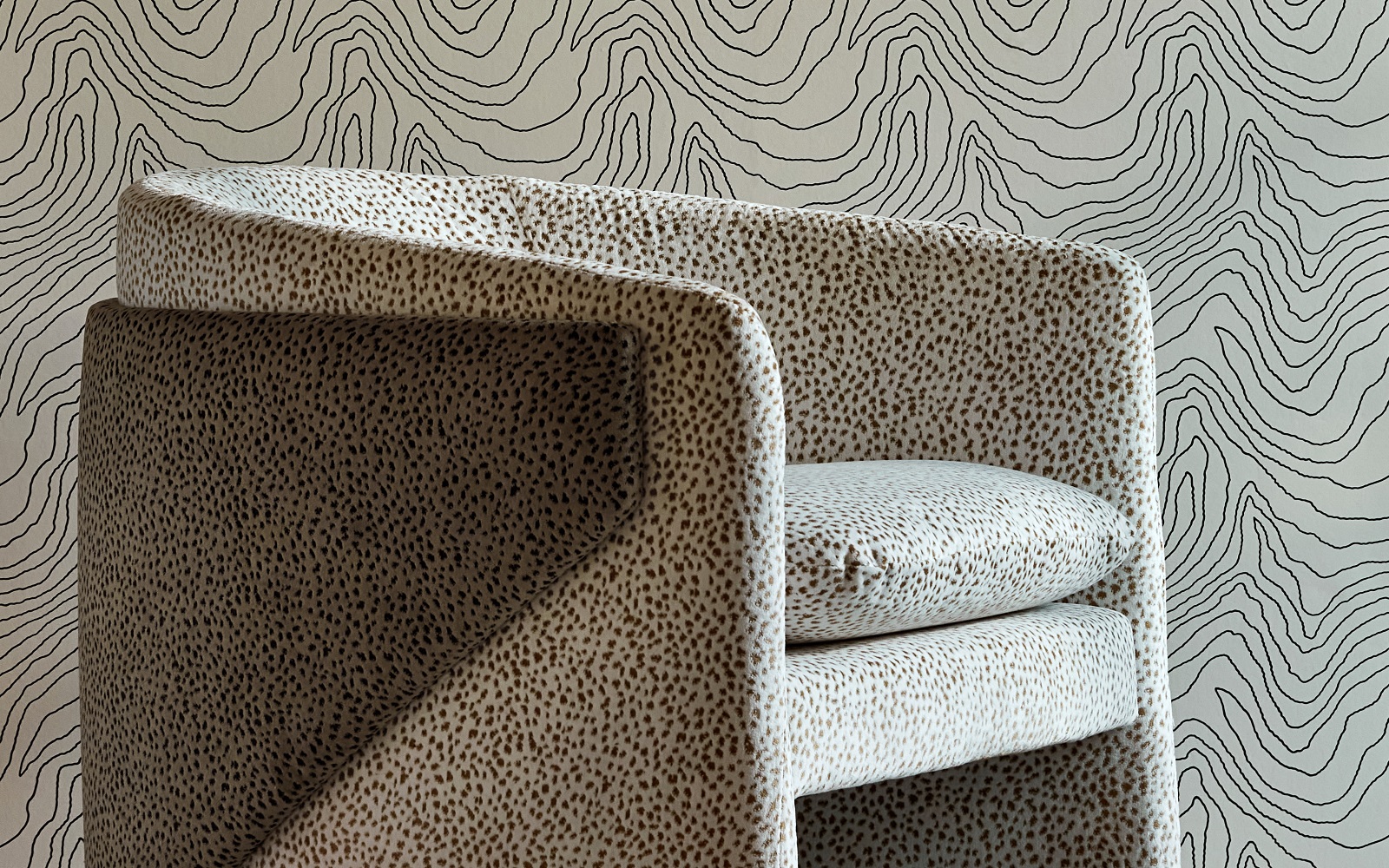 black and stone patterned wallpaper with patterend chair in same colourway from Harlequin Reflect