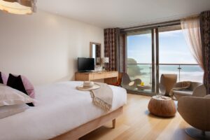 hypnos bed with views out across the cornish coast