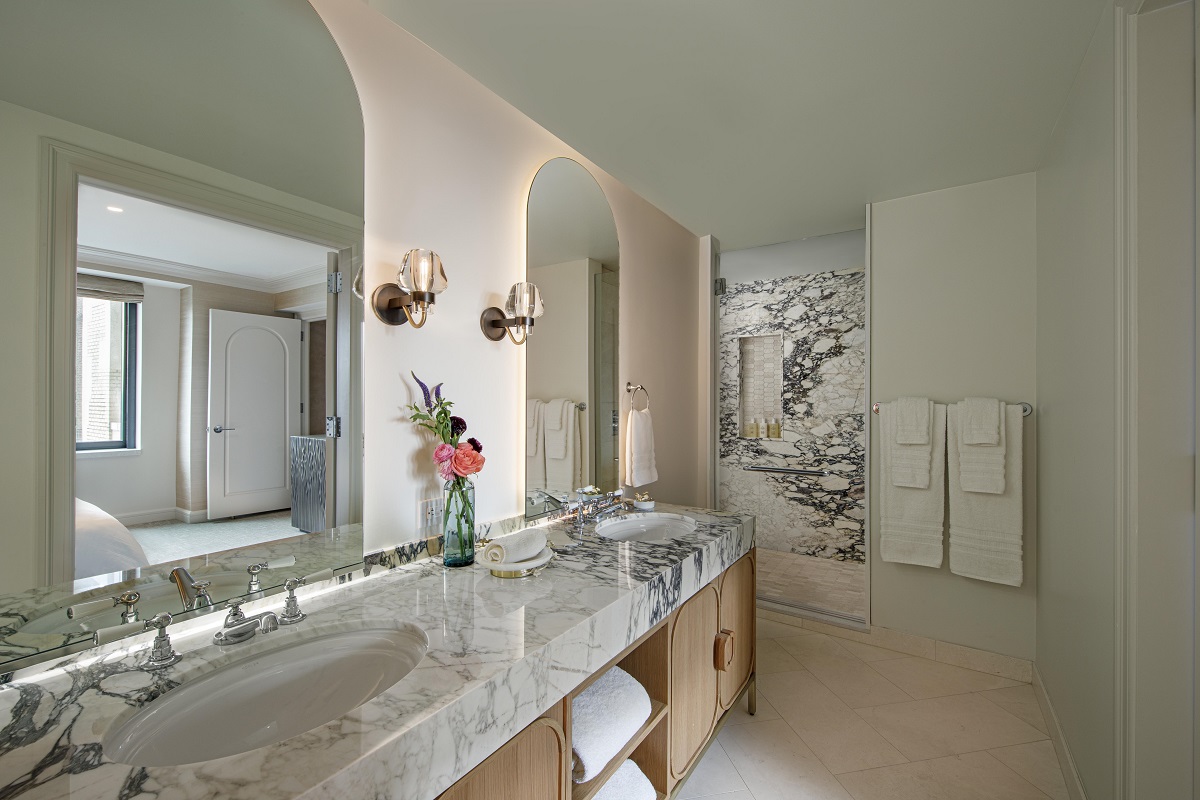 bathroom with long marble vanity and double basin