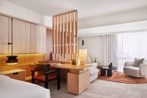 guestroom in The Jay with wooden screen dividing seating area