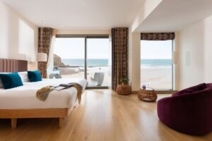 guestroom at Scarlet with floor to ceiling glass windows looking onto the beach
