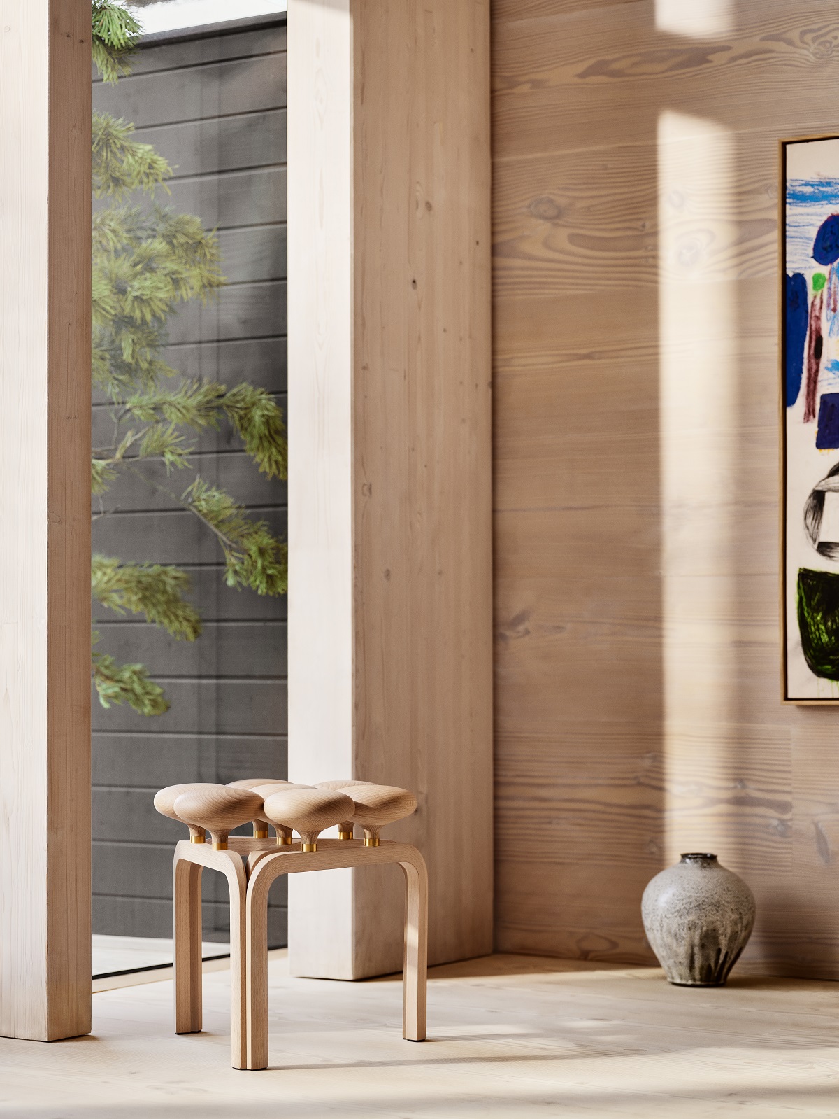 Utzon wooden chair in front of floor to ceiling window in minimalist interior