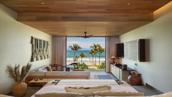 Punta de Mita Wow suite with view from bed out onto palm trees and beach