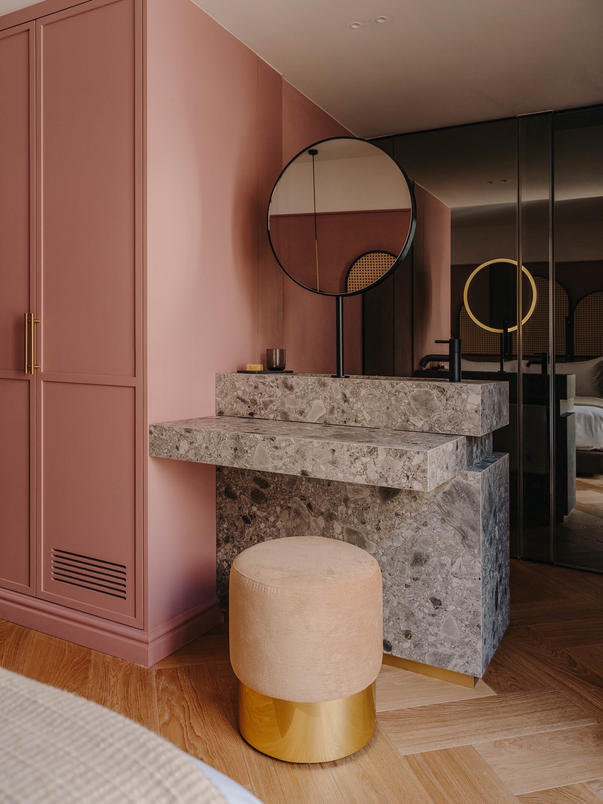 pink walls and stone vanity in guestroom
