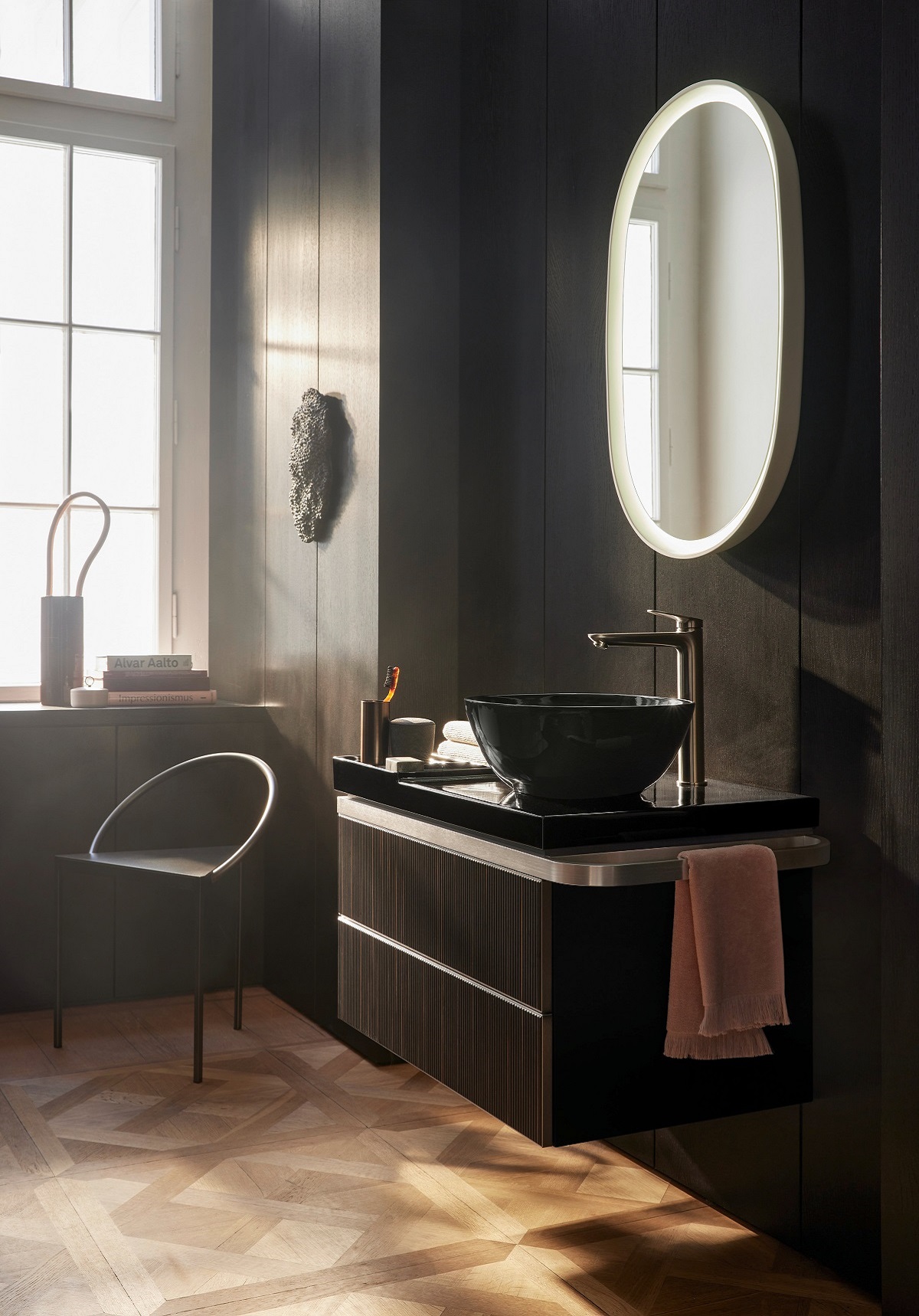 black basin on vanity unit in bathroom against black wall