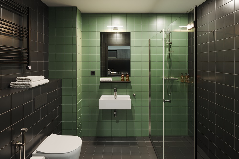 green tiled bathroom in The Social Hub San Sebastian