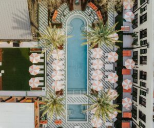 birds eye view of signature pool, cabanas and palm trees at Hotel Bardo