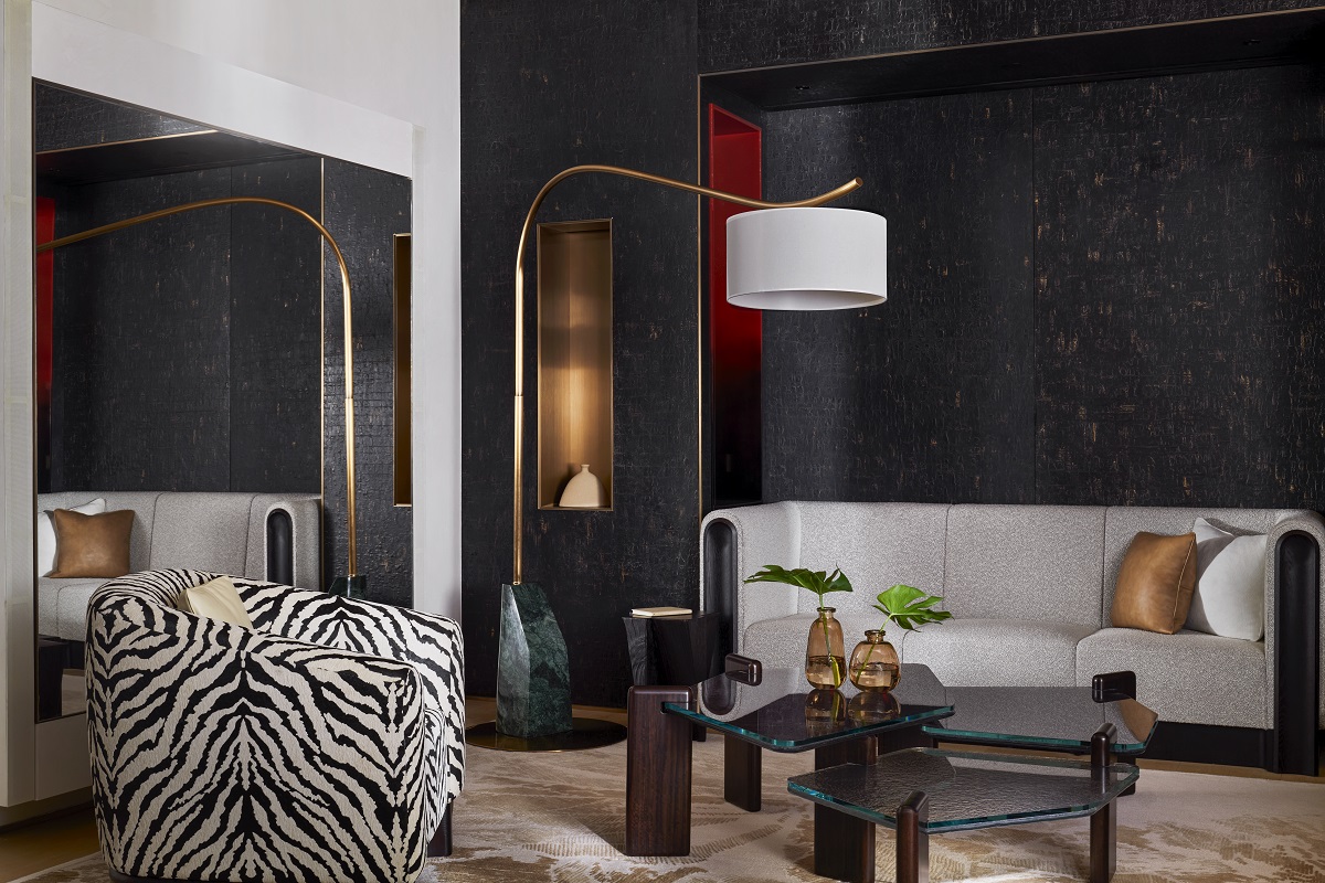 zebra striped chair and cream couch against black wall in hotel suite