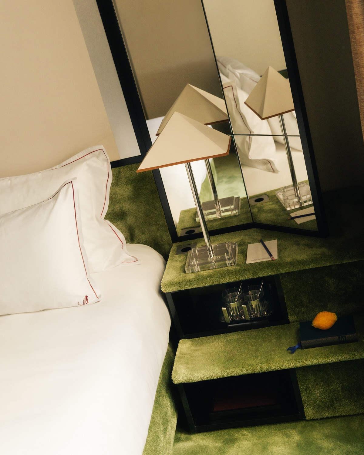 glass and green carpet bedside detail in Hotel Chateau d'Eau