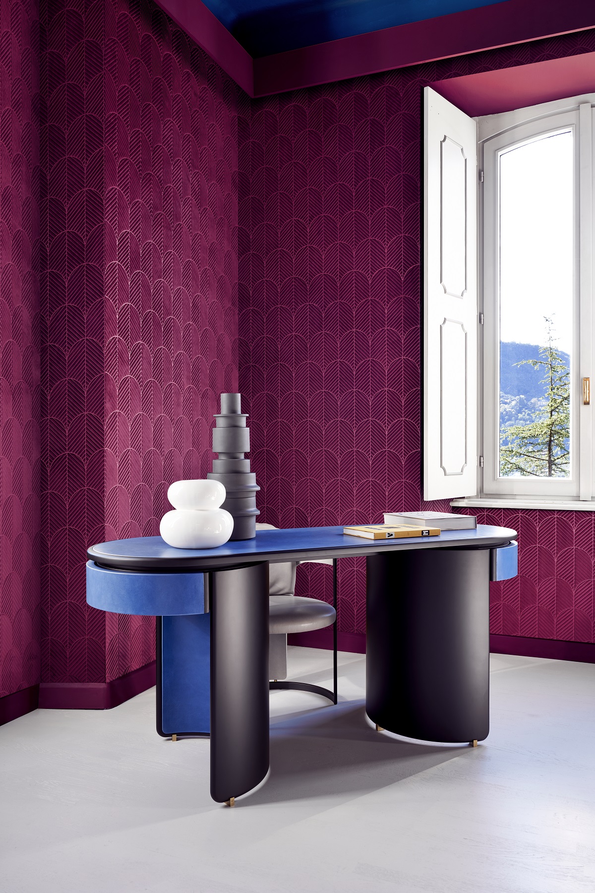 deep purple wallcovering behind statement blue and wood desk