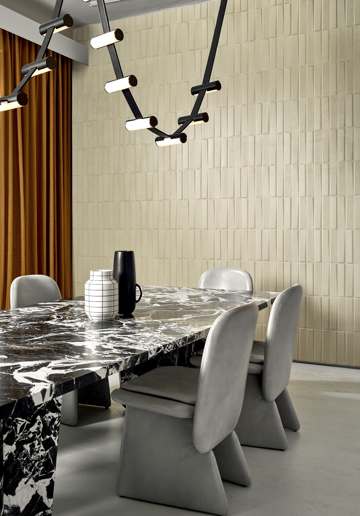 cream textured wall behind marble table and contemporary architectural light