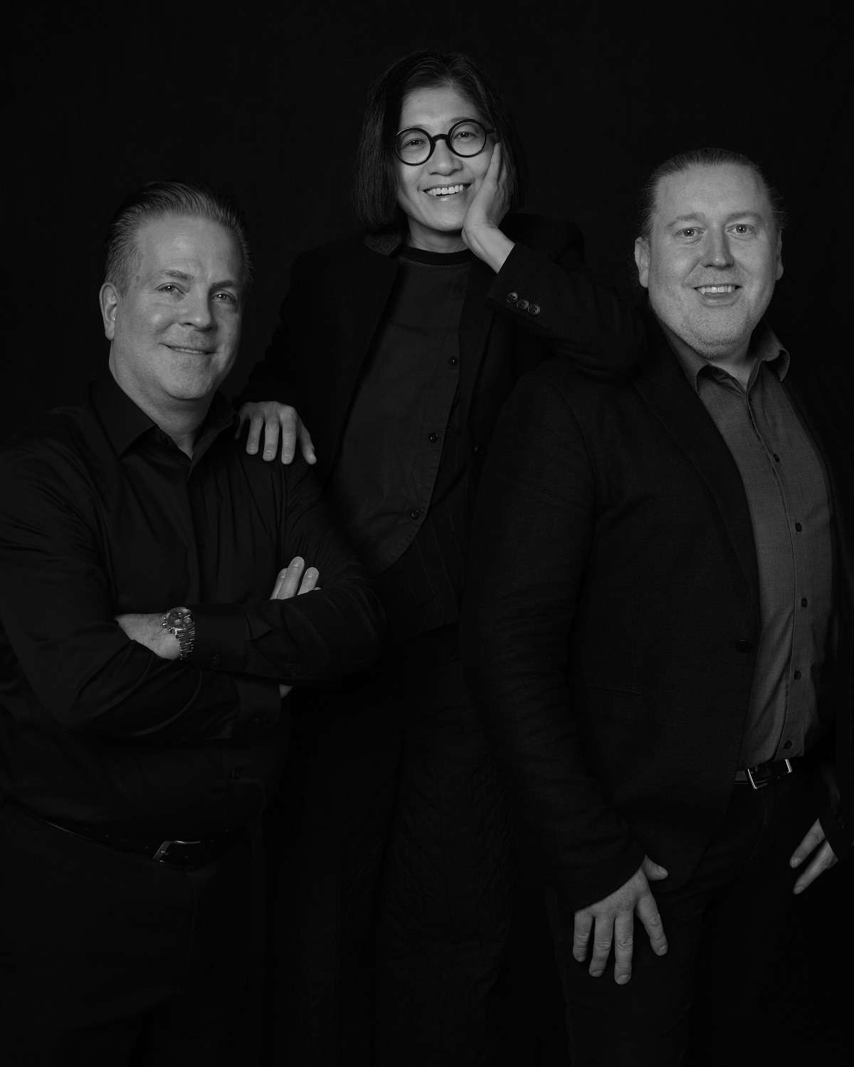 A black and white image of the three new partners of Jeffrey Beers International, from left to right: Michael Pandolfi, AIA, Nora Liu-Kanter, and Tim Rooney
