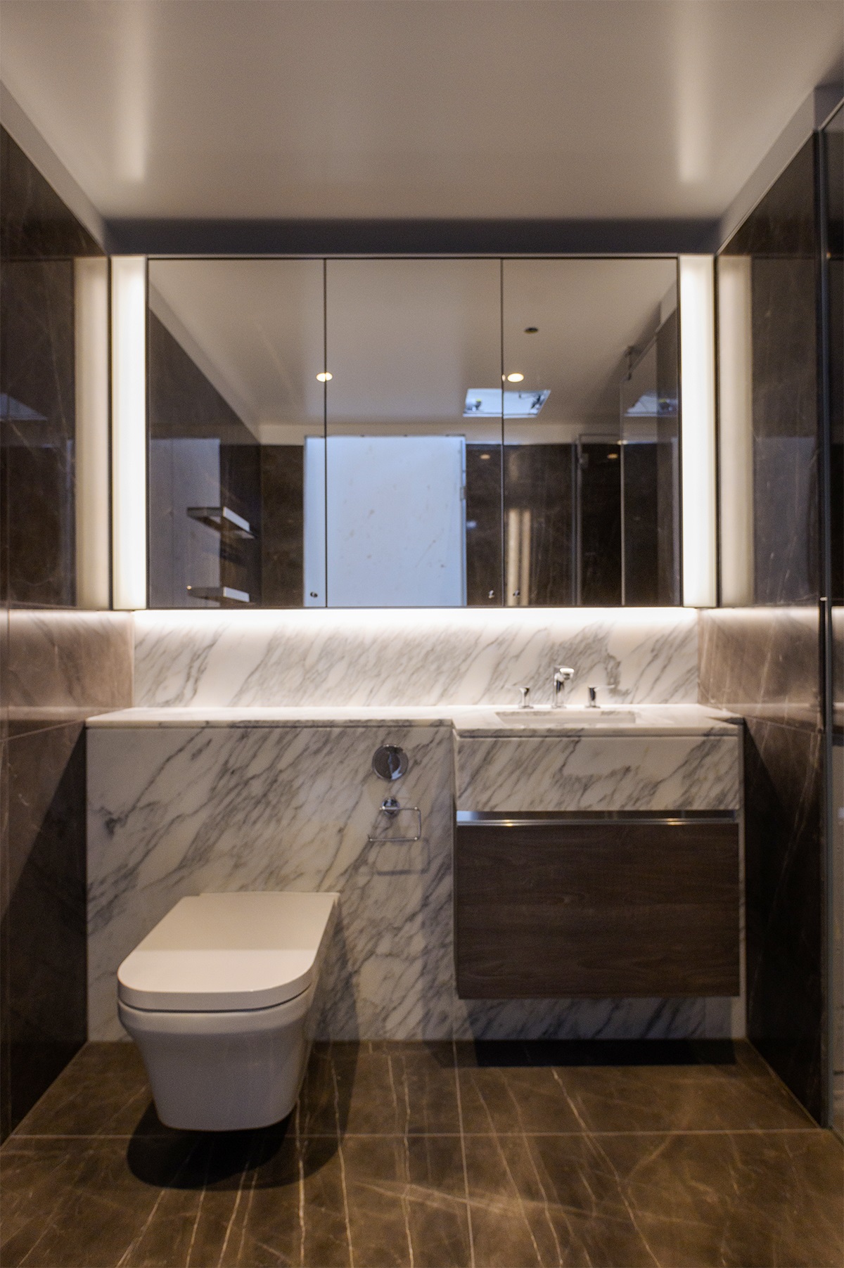 mirror, toilet and vanity in bathroom pod at Regents Crescent by StoneBathwear