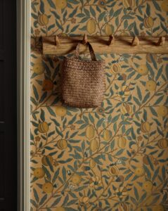 hallway with basket on hook and lemon and leaf wallpaper