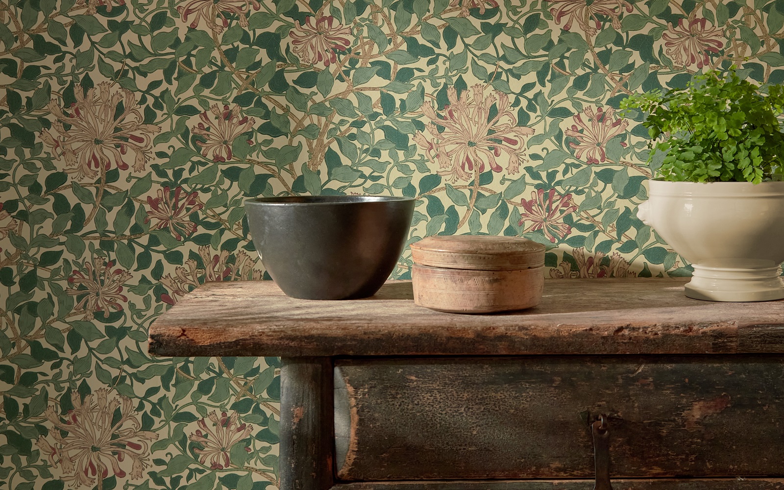wooden shelf with bowls in front of morris & co wallpaper