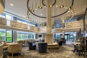 A bespoke statement light developed by Northern Lights turns the central pillar into an experiential focal point at Hilton London Croydon