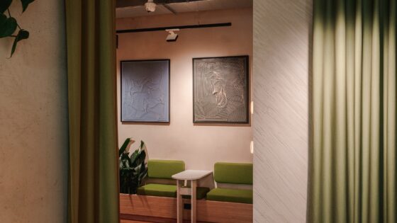 hotel lobby with art work above green banquette