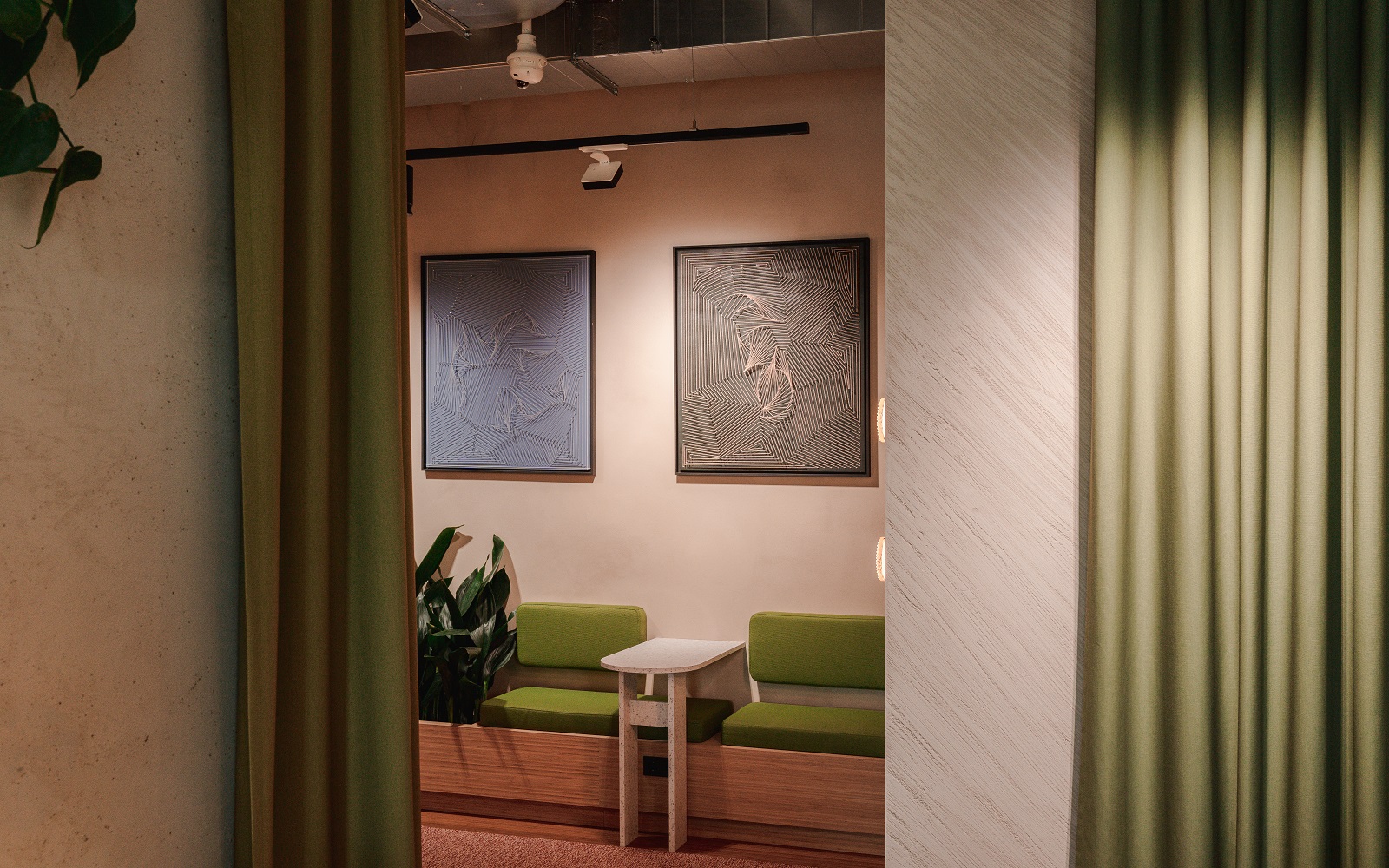 hotel lobby with art work above green banquette