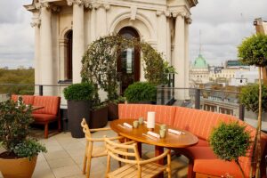 roof terrace at OWO with seating and table alongside period architectural features
