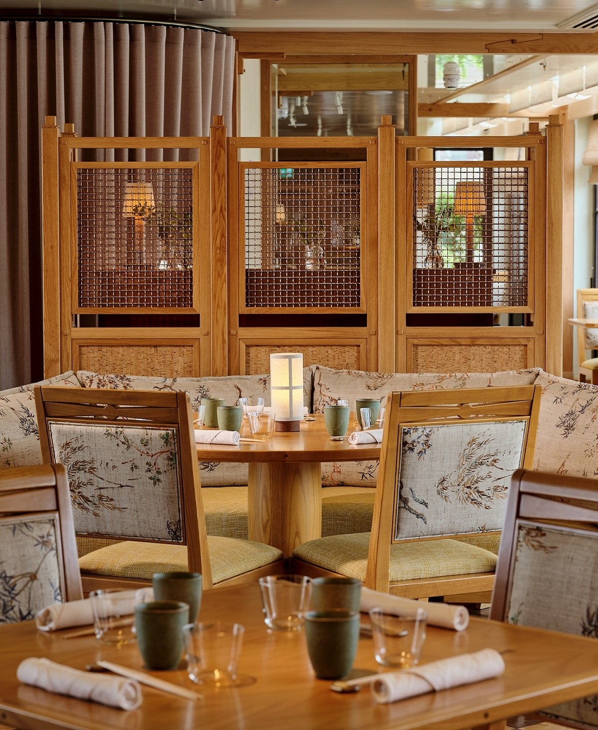 wooden panel and table detailing in the restaurant with japanese inspired fabric details