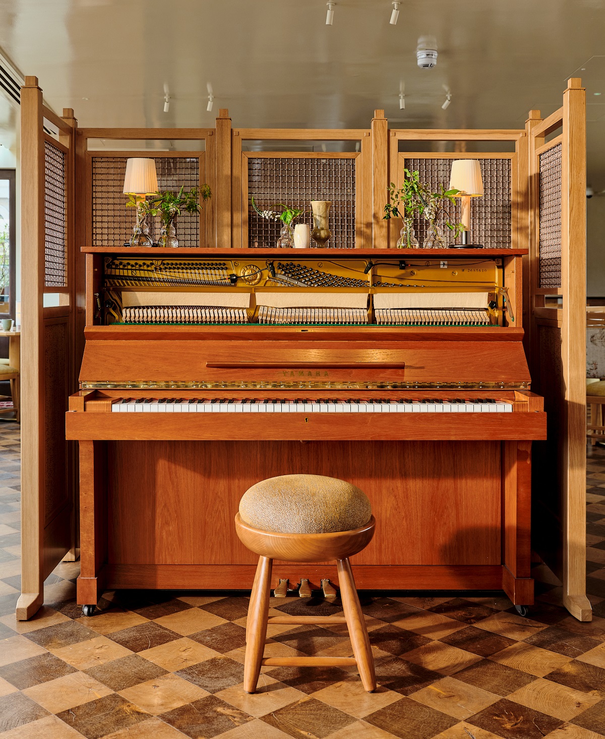 checked floor, vintage piano and wooden stool in Kioku