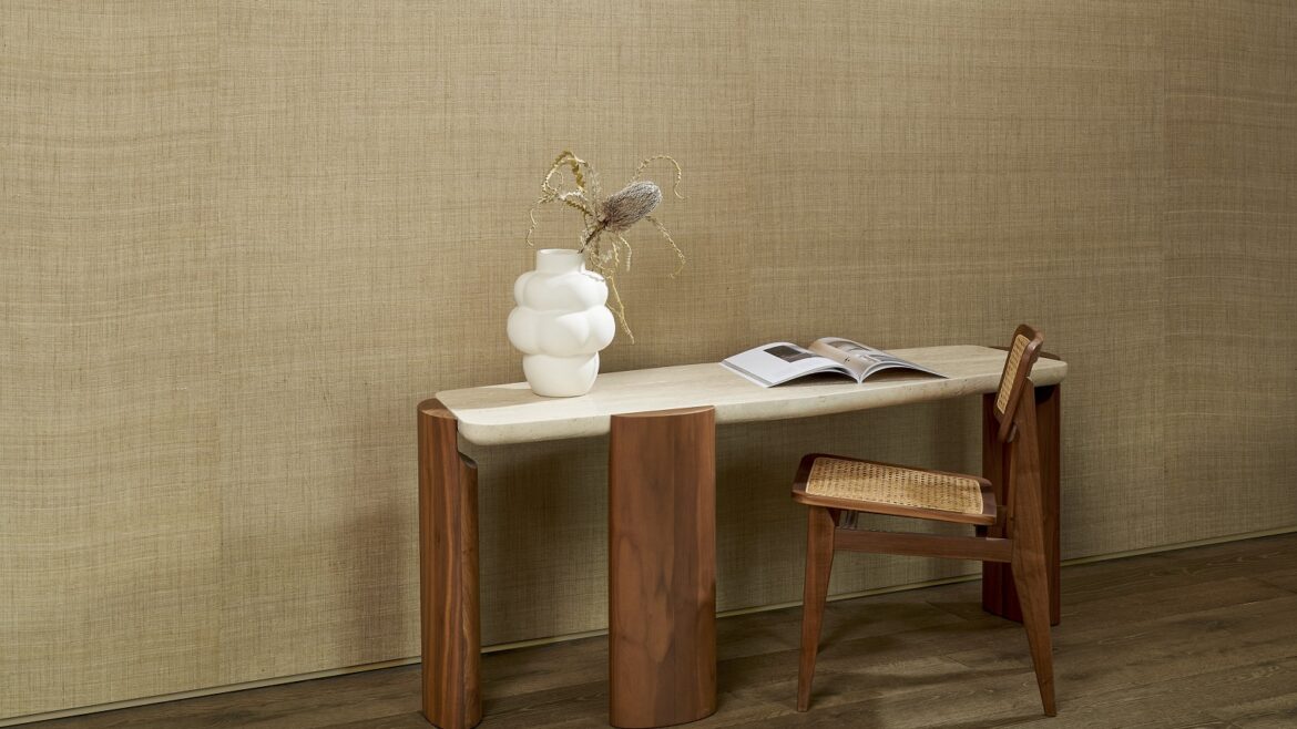 wooden table and chair with white vase against natural silk wall covering from Arte