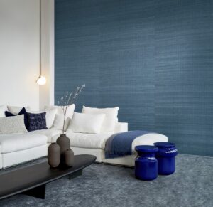 blue silk wallcovering behind white couch
