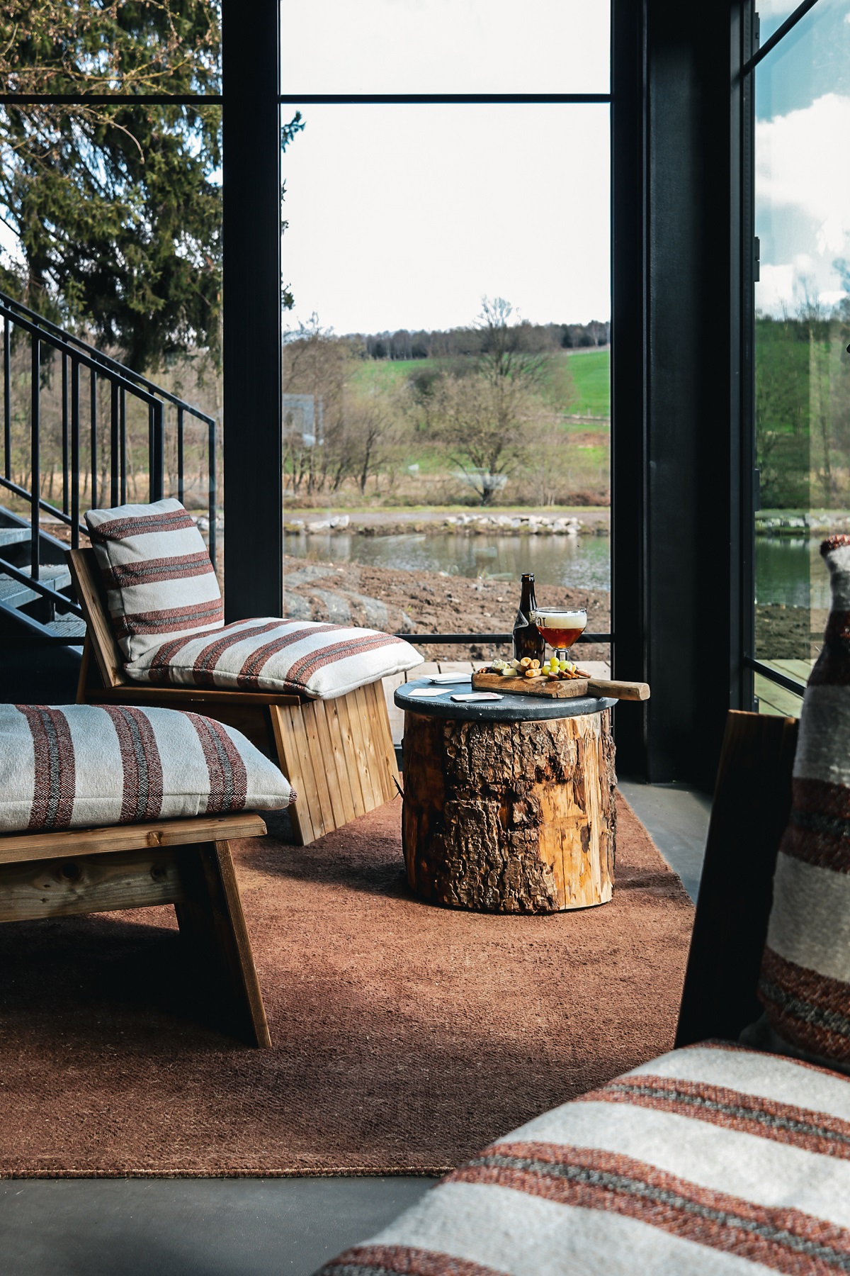 tree stump table and natural fabrics in seating area in forest resort