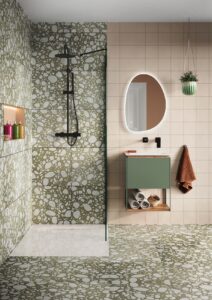 moss green mottled shower and bathroom floor with pebble shaped illuminated mirror