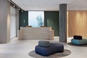 reception desk, organic shaped seating and pillars at the entrance to Fairfield Copenhagen