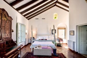 four poster bed under a beamed ceiling in a traditional spanish finca boutique hotel